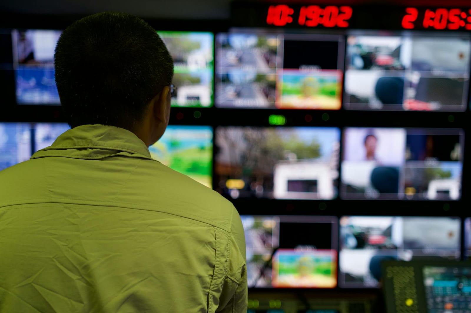 A wall of monitors tracking live coverage.