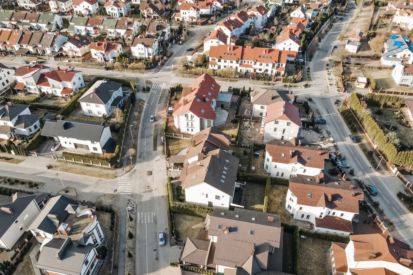 Rows of suburban houses seen from above, streets dividing them into neat blocks.