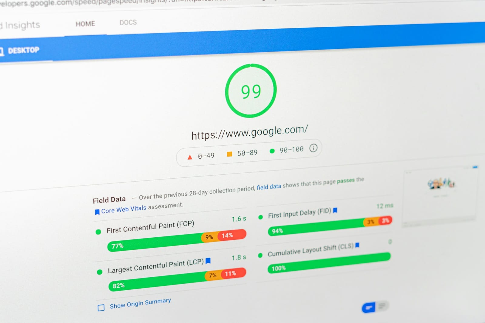 A laptop screen showing a Google PageSpeed Insights report — a green performance score of 99 above Core Web Vitals metrics including First Contentful Paint, Largest Contentful Paint and Cumulative Layout Shift.