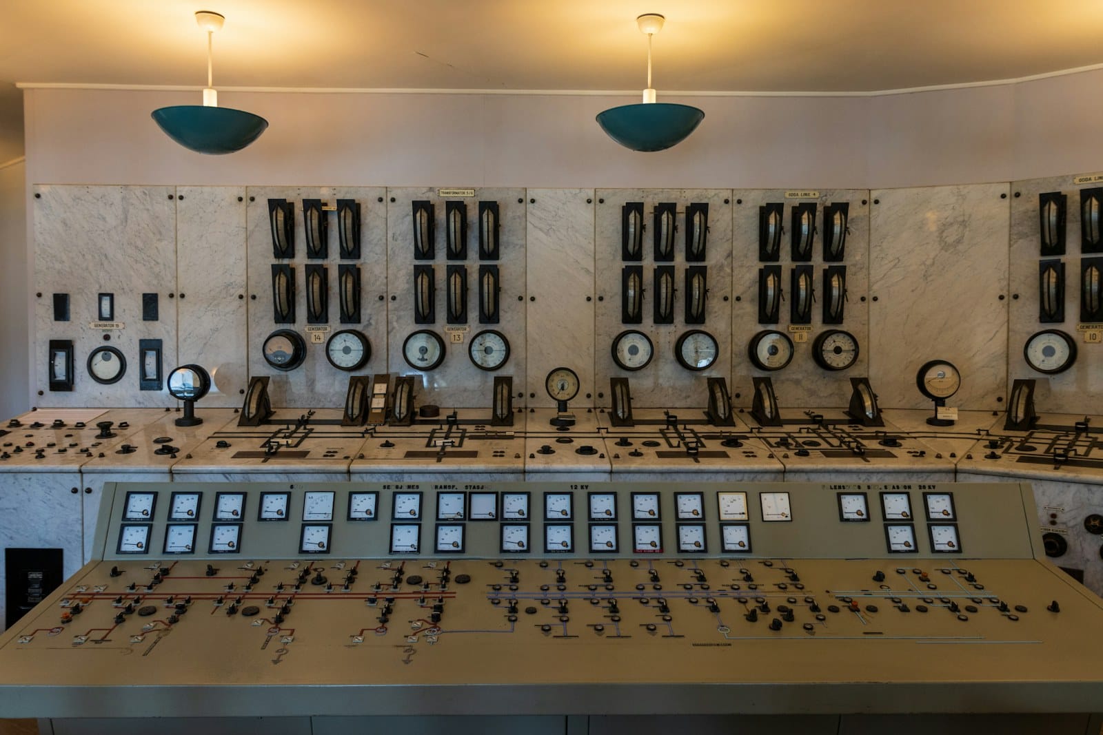 A control room lined with consoles and instrument panels.