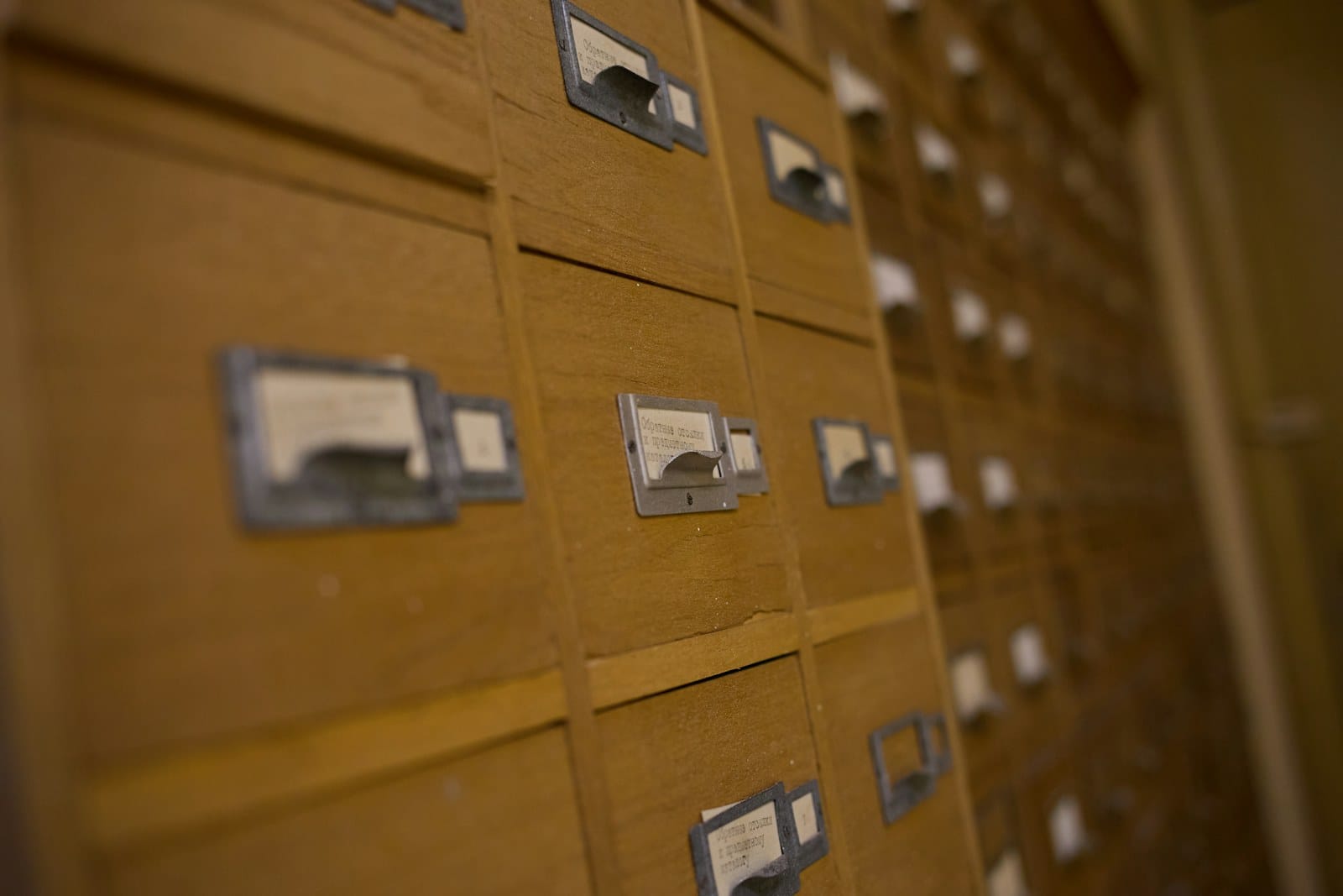 Wooden card-catalogue drawers with handwritten labels.