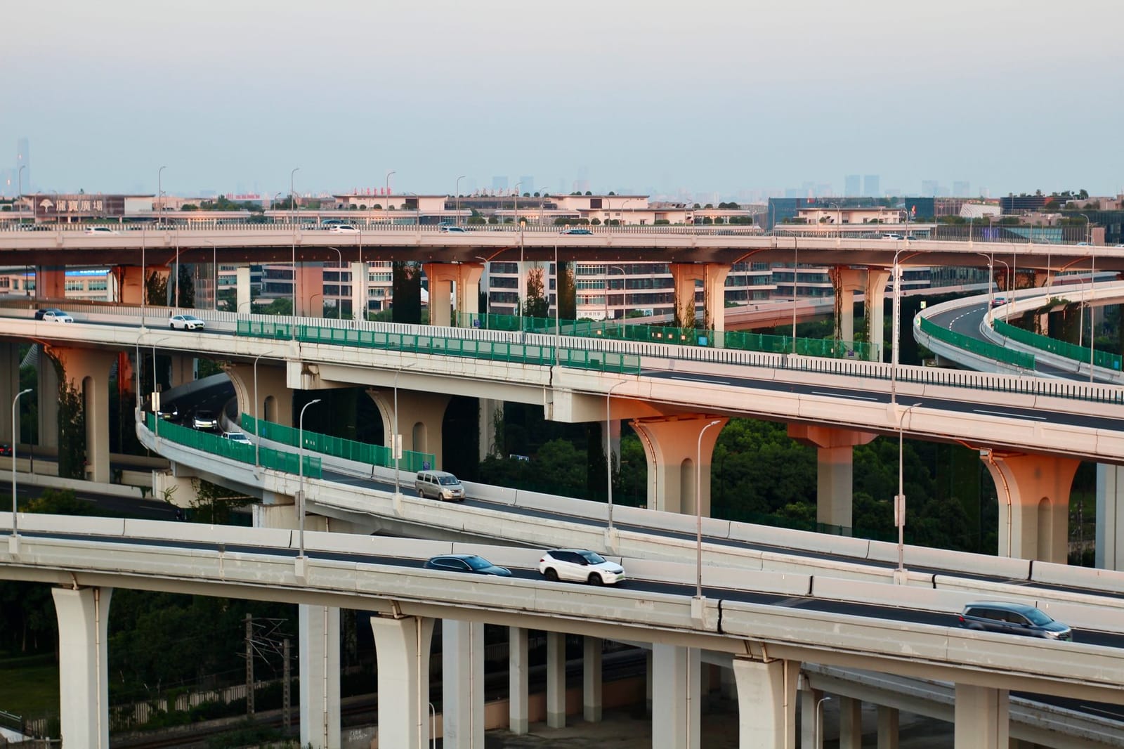 A stacked motorway interchange at dusk, several carriageways crossing at different levels.