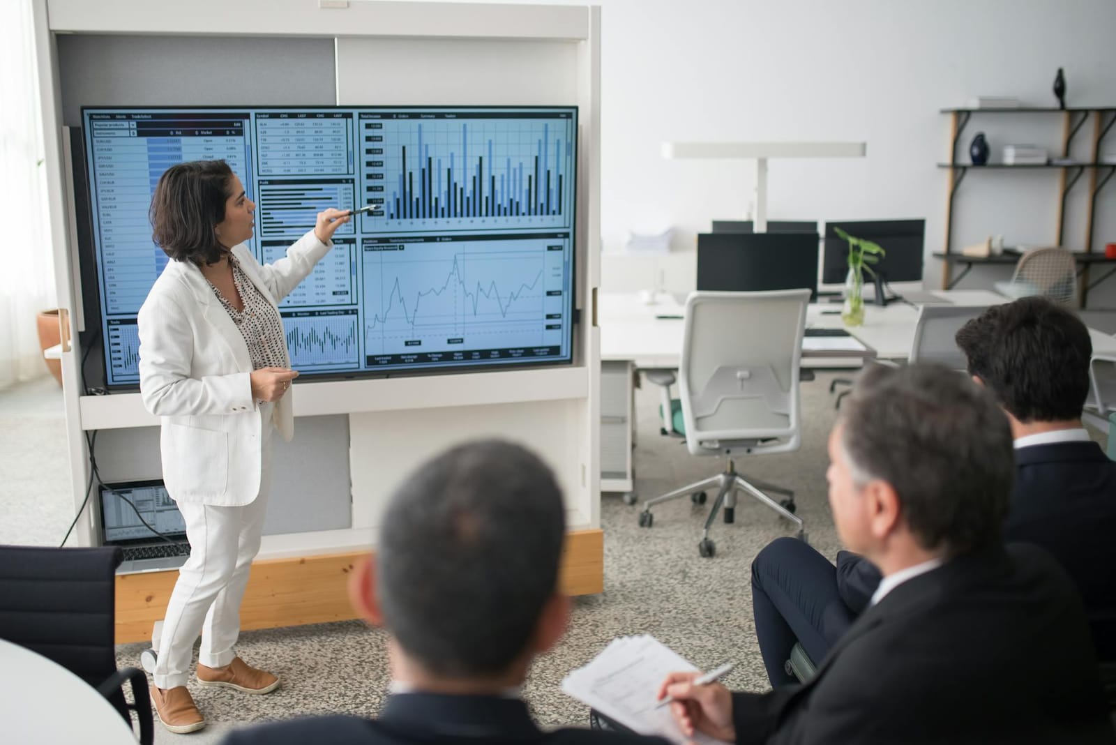 A team working at screens in a modern operations room, representing a coordinated crisis response.