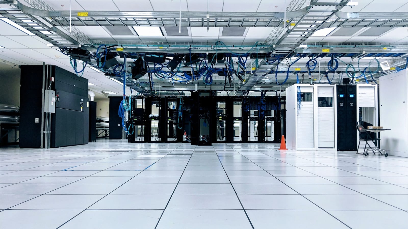 A data centre with rows of server racks and network cabling.