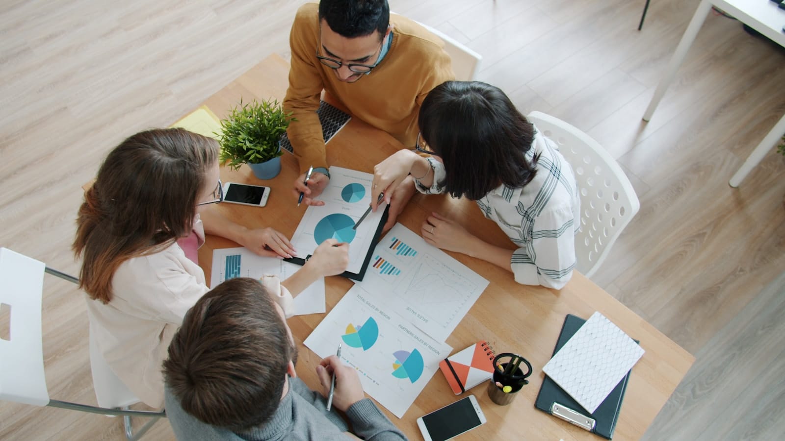 A team collaborating around a table in a bright office.
