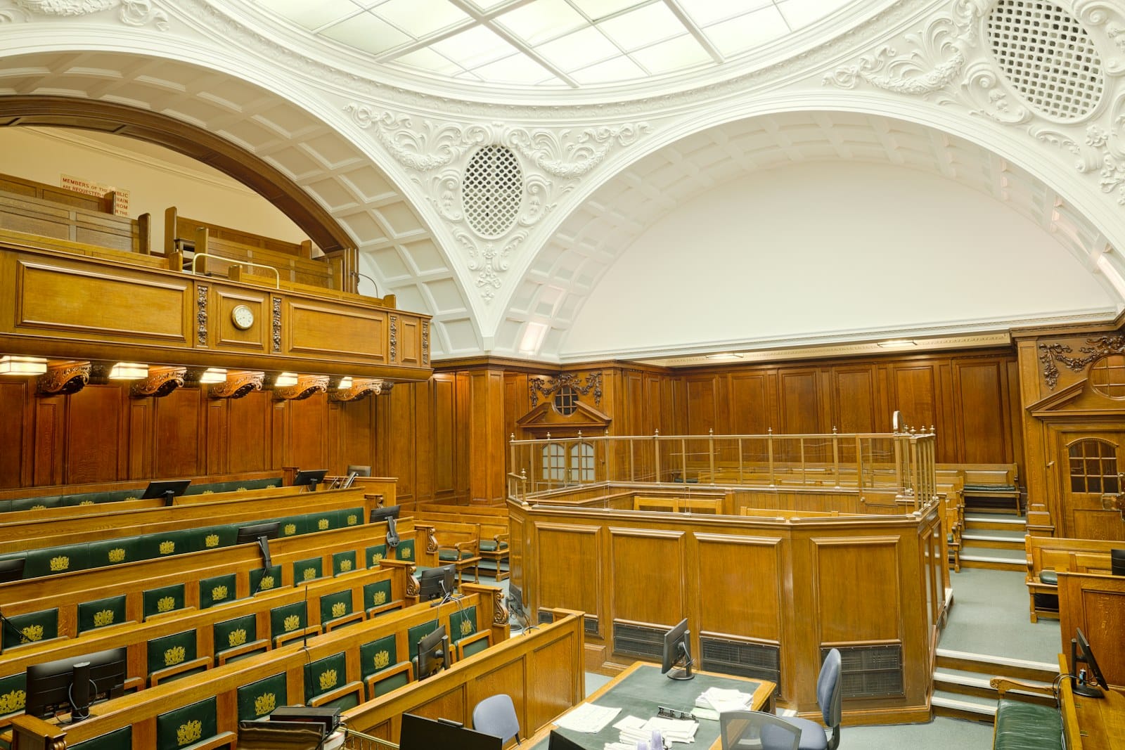 An empty courtroom in dark panelled wood.