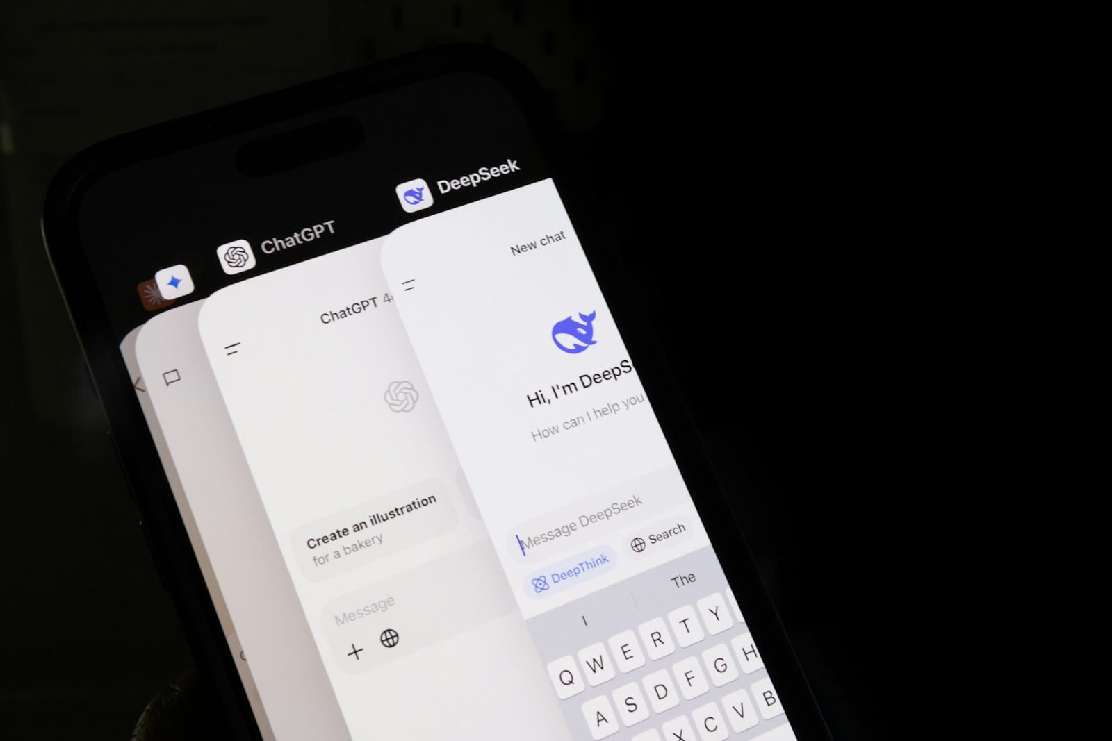 A phone showing ChatGPT and DeepSeek app windows side by side.