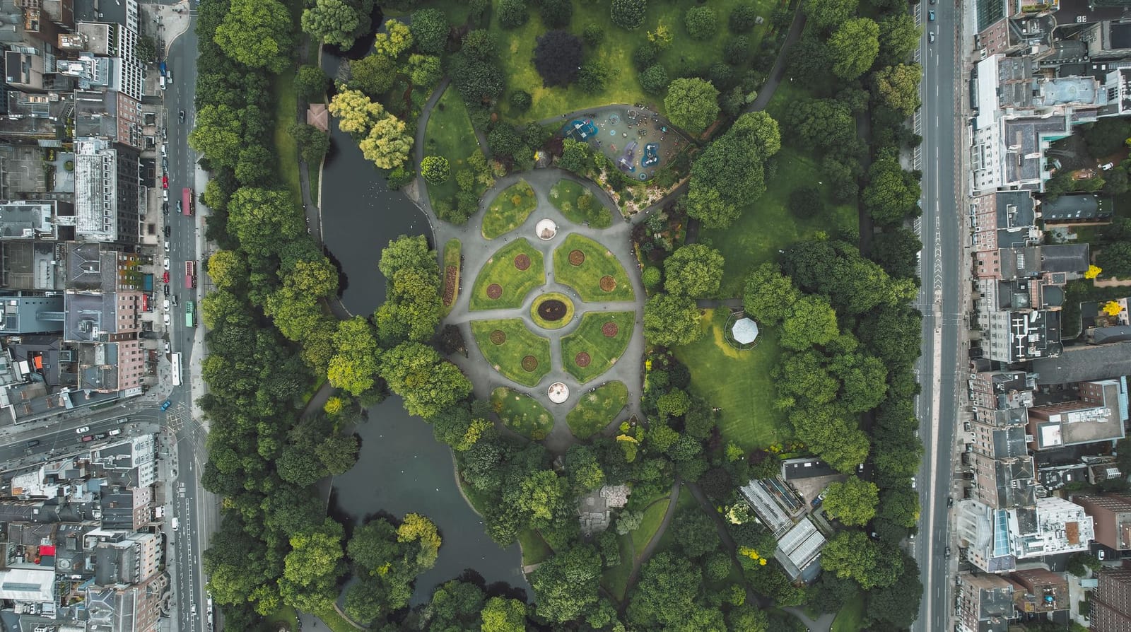 A city park seen from directly above, its boundary drawn sharply against the surrounding streets and buildings.