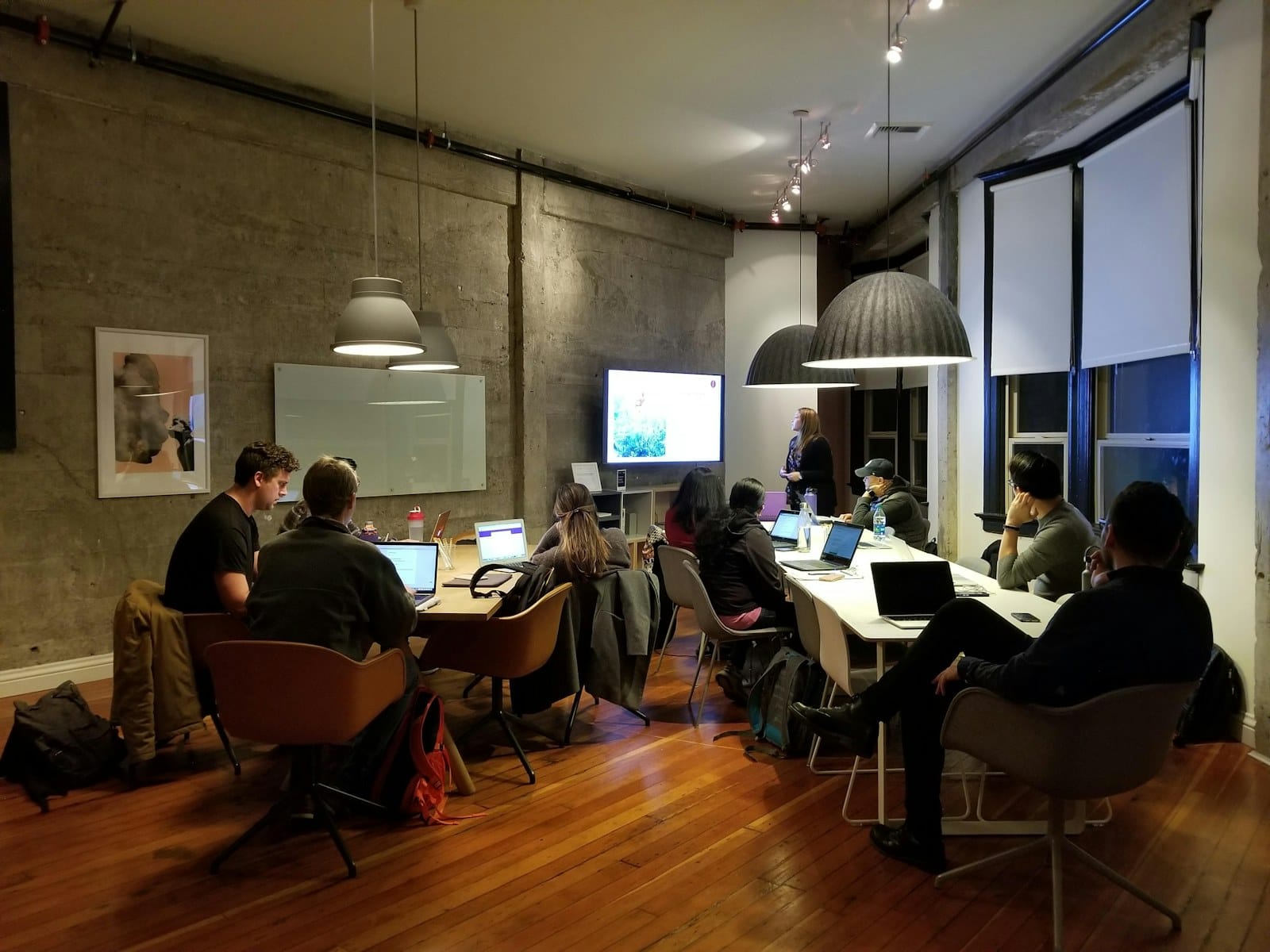 A communications agency team working together around laptops.