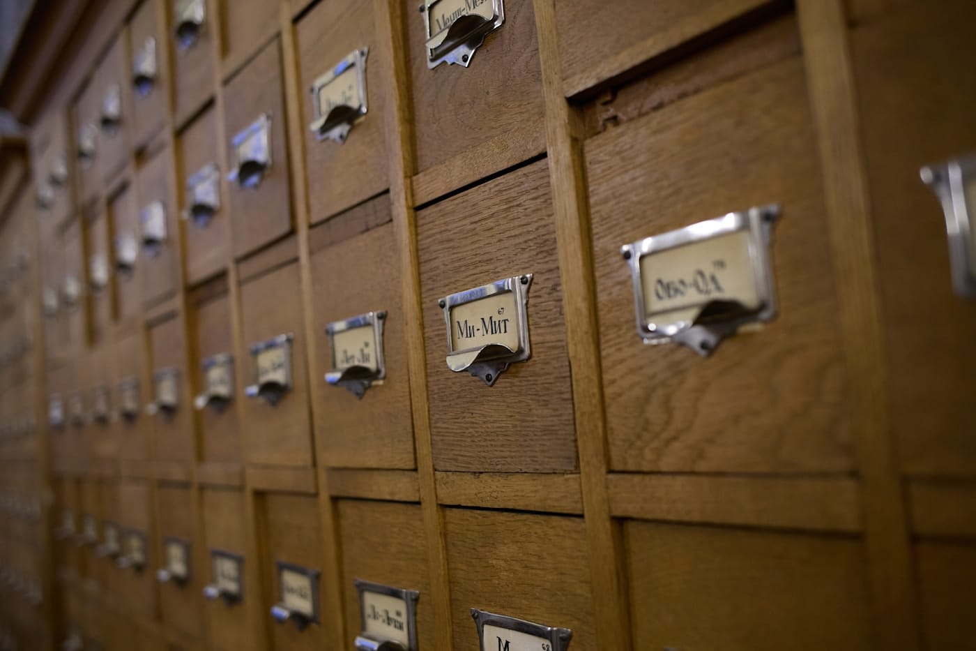 Wooden library card-catalog drawers with alphabetical labels, the kind of indexing system a citation-selection process mirrors.
