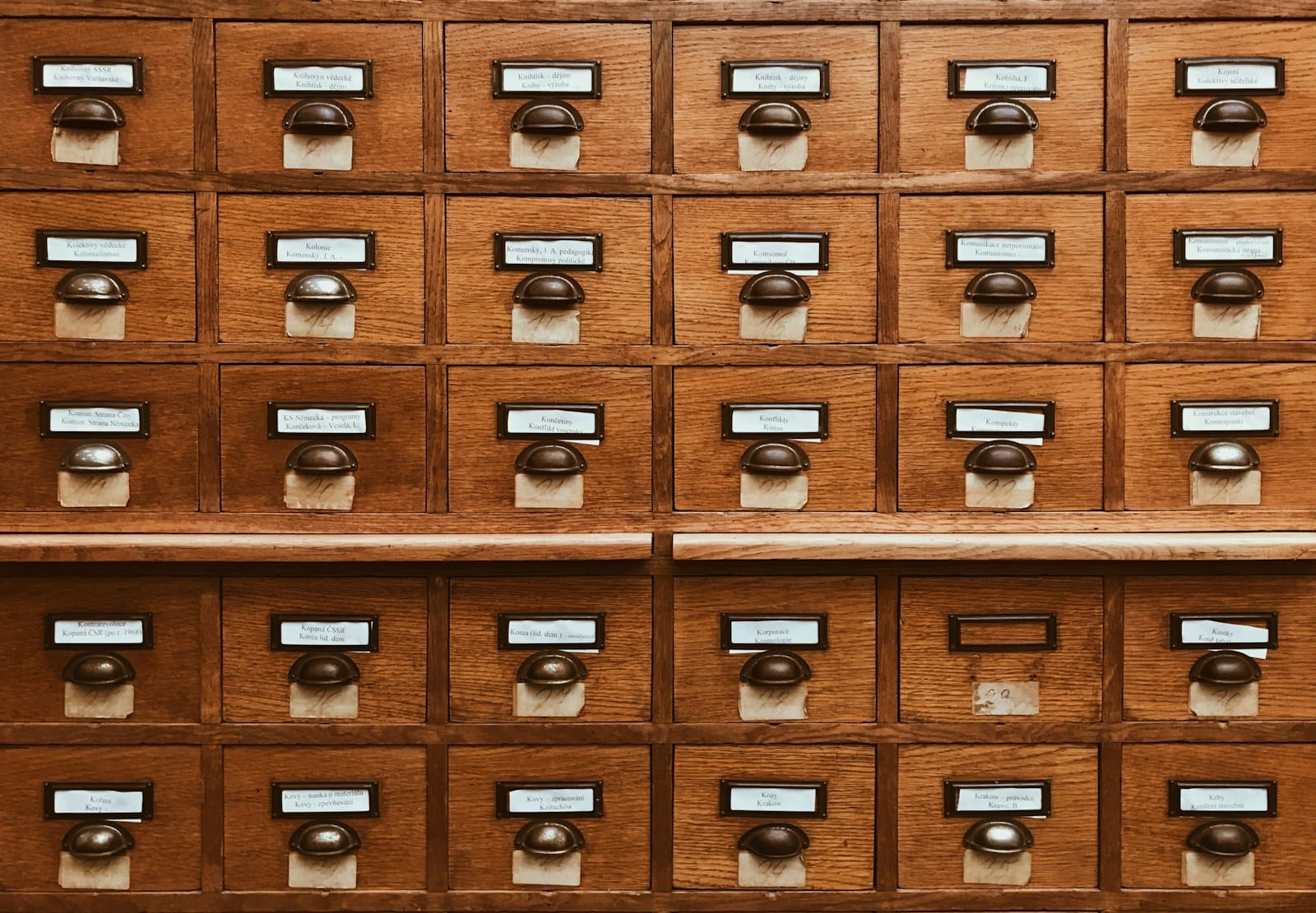Library archive shelves, representing the durable, off-platform record that search and AI surface.